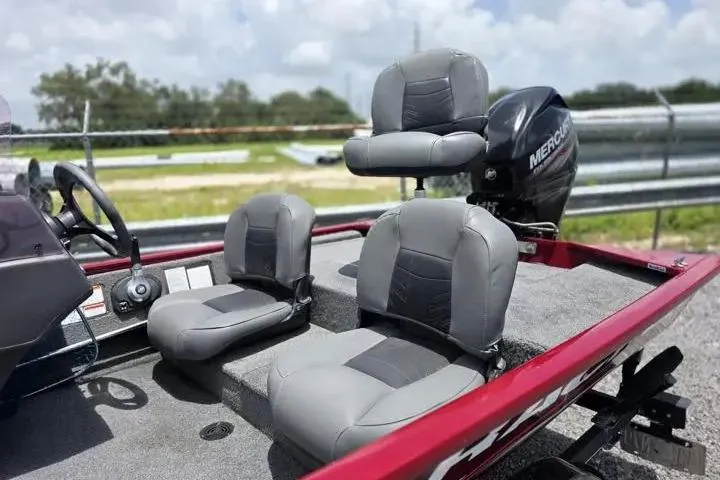 Slide: The Image of 2020 Tracker Pro 160 boat interior with gray seats and Mercury engine. - 11