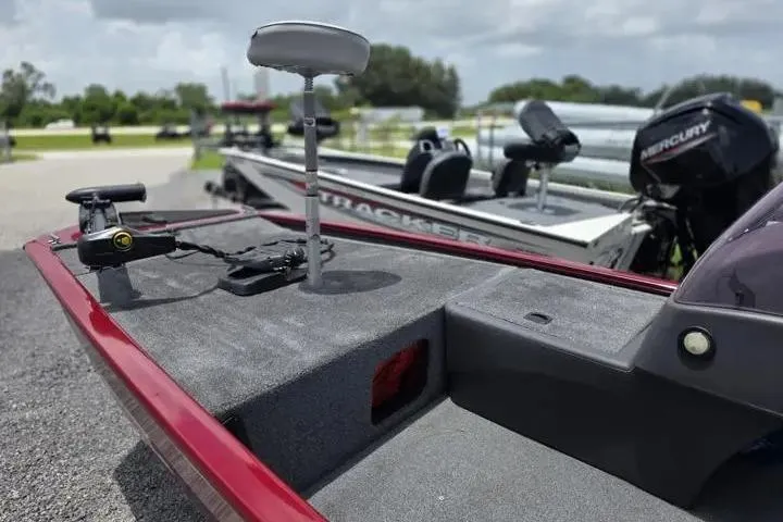 Slide: The Image of 2020 Tracker Pro 160 boat with fishing seat and motor, parked outdoors. - 12