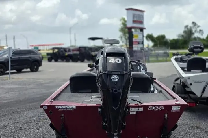 Slide: The Image of 2020 Tracker Pro 160 boat with 40 HP motor in a parking lot. - 5