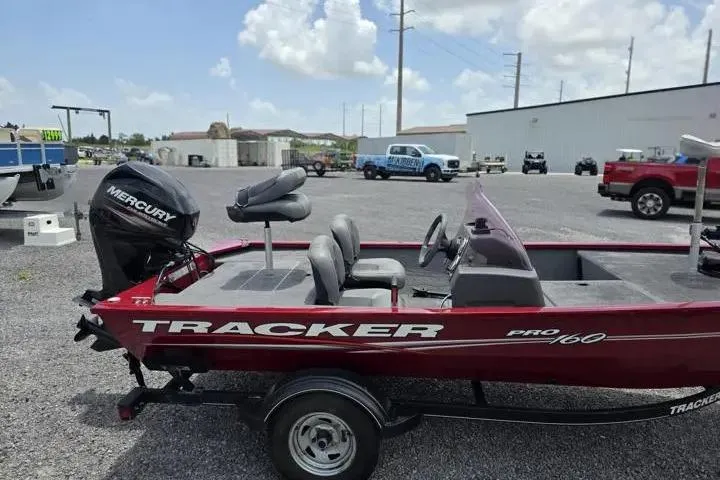 Slide: The Image of 2020 Tracker Pro 160 boat with Mercury engine in a parking lot. - 7
