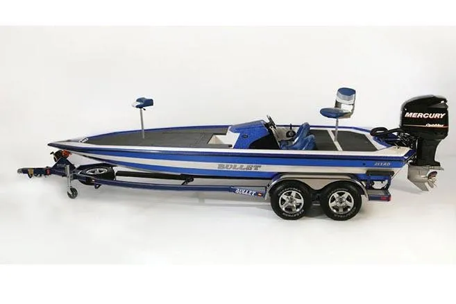 Slide: The Image of 2021 Bullet 21XRD boat interior with red seats and steering wheel on a sunny day. - 9