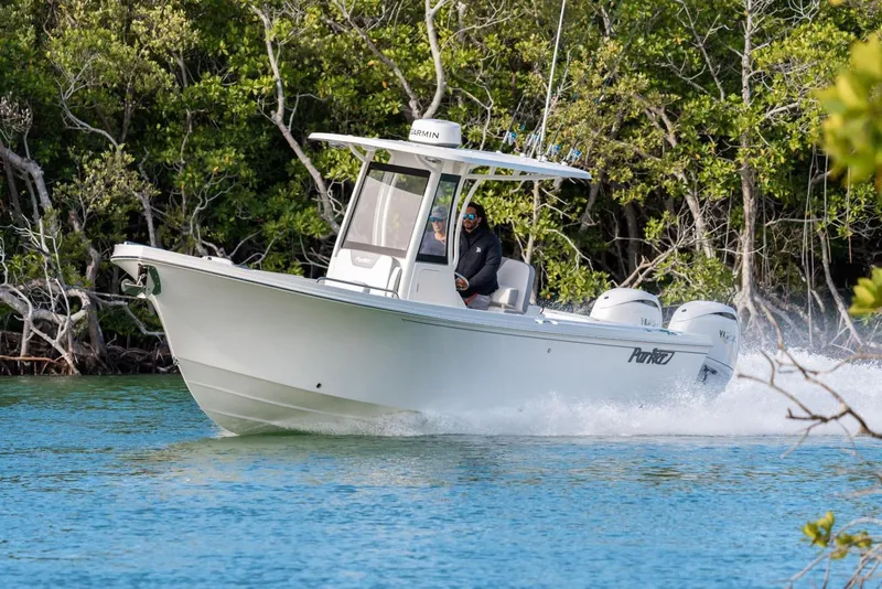 The Image of Manufacturer Provided Image: 2026 Parker 274 Fathom boat cruising on a scenic waterway with lush greenery. - 0