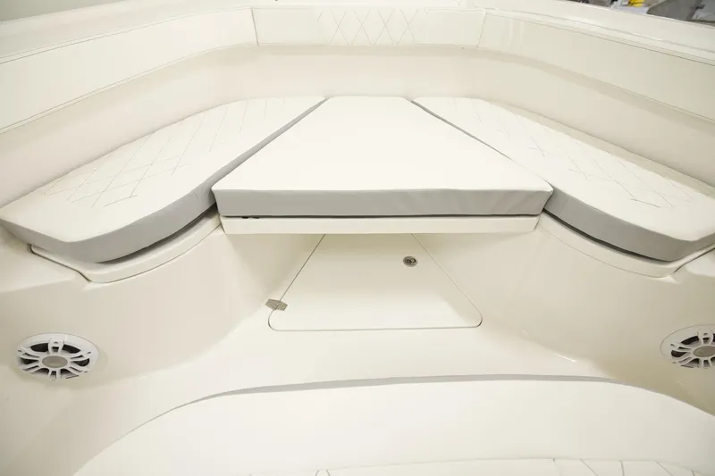 Slide: The Image of 2026 Parker 274 Fathom boat interior with cushioned seating and speaker system. - 5