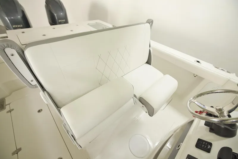 Slide: The Image of 2026 Parker 274 Fathom boat interior with white seating and dual engines. - 8