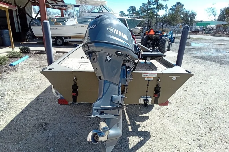 Slide: The Image of 2024 G3 Gator Tough 1652 VBW boat with Yamaha outboard motor, parked outdoors. - 16