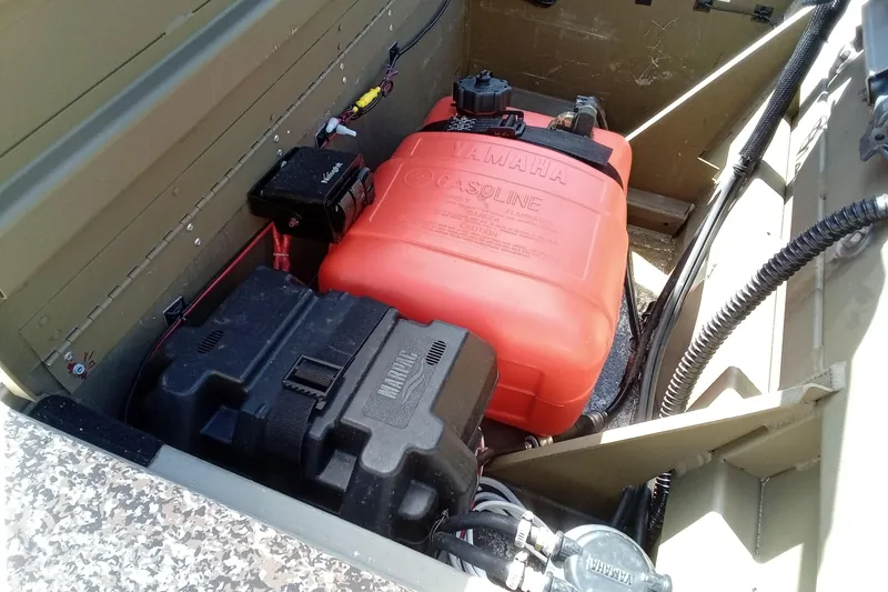 Slide: The Image of 2024 G3 Gator Tough 1652 VBW boat interior with Yamaha gasoline tank and battery. - 17