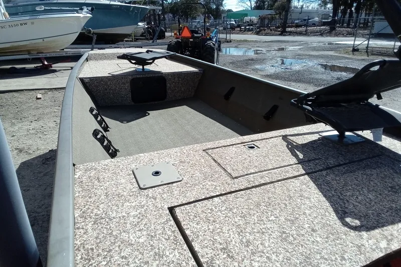 Slide: The Image of 2024 G3 Gator Tough 1652 VBW boat, spacious interior, durable design, parked outdoors. - 18