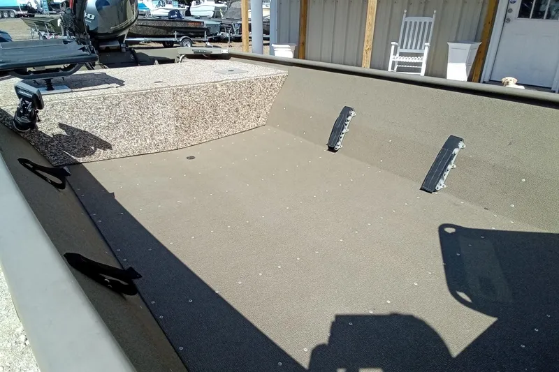 Slide: The Image of 2024 G3 Gator Tough 1652 VBW boat interior with spacious deck and motor. - 8