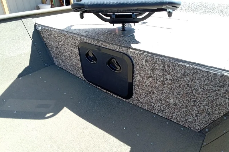 Slide: The Image of 2024 G3 Gator Tough 1652 VBW boat interior with textured panel and mounted seat. - 9