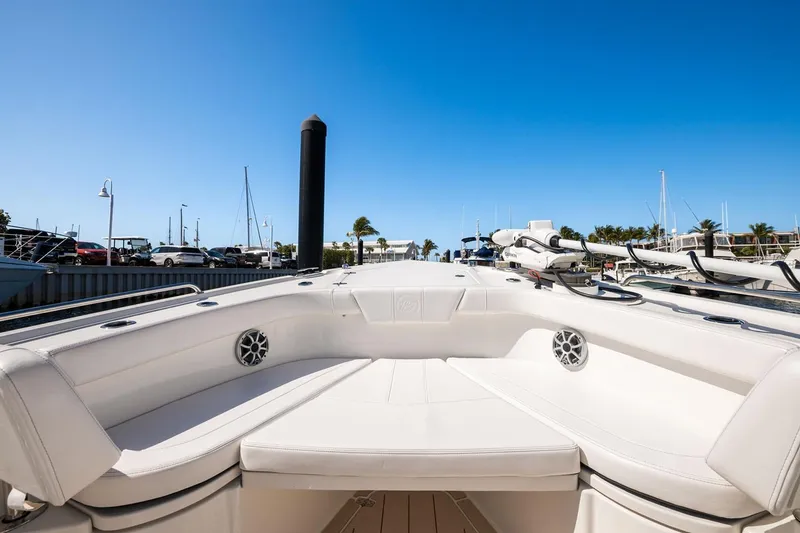 Slide: The Image of Manufacturer Provided Image: 2026 Parker 294 Fathom boat interior at marina, showcasing sleek white seating and clear blue sky. - 3