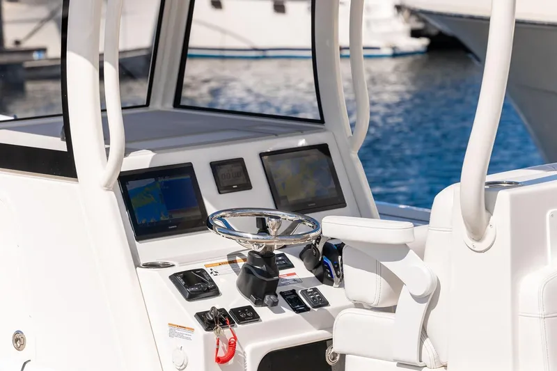 Slide: The Image of Manufacturer Provided Image: Helm of 2026 Parker 294 Fathom boat with modern navigation displays and controls. - 7