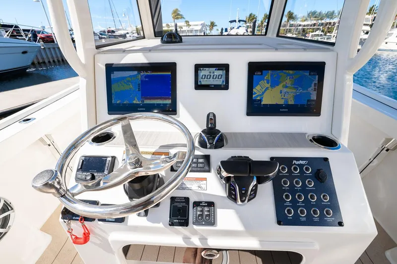 Slide: The Image of Manufacturer Provided Image: Helm of 2026 Parker 294 Fathom boat with advanced navigation displays and controls. - 8