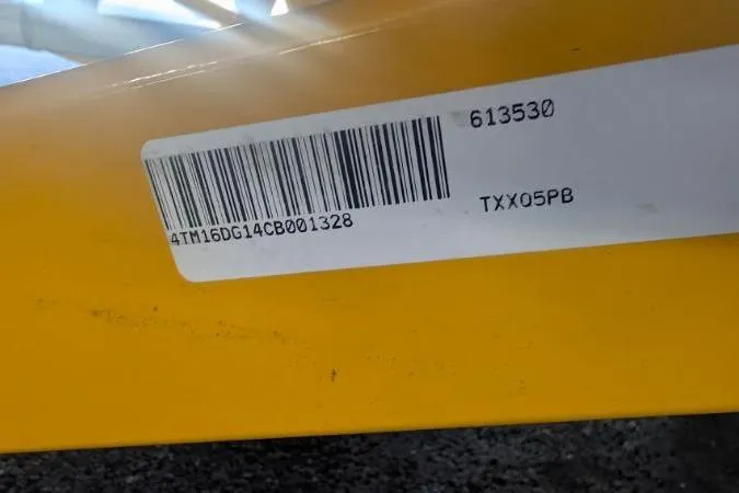 Slide: The Image of Barcode and serial number on yellow Tahoe Q5L I/O 2012 vehicle component. - 10