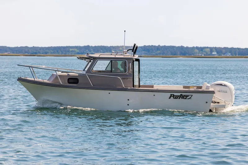 Slide: The Image of Manufacturer Provided Image: 2026 Parker 217 Explorer boat cruising on calm water. - 2