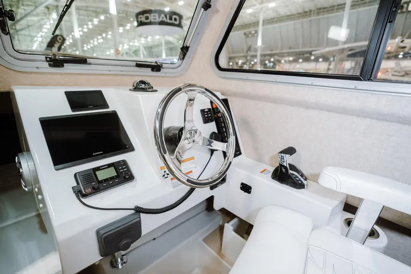 Slide: The Image of Manufacturer Provided Image: Interior of 2026 Parker 217 Explorer boat with modern steering and navigation controls. - 7