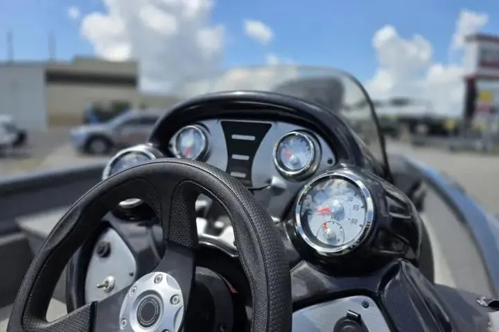 Slide: The Image of 2020 Tracker Pro Team 175 TF boat dashboard with steering wheel and gauges. - 18