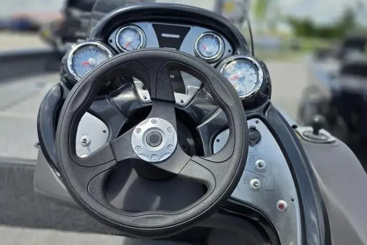 Slide: The Image of 2020 Tracker Pro Team 175 TF boat dashboard with steering wheel and gauges. - 19