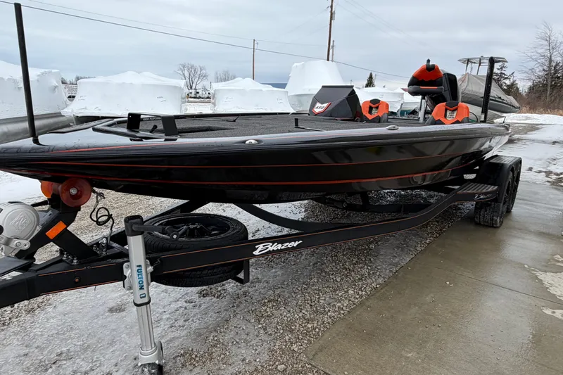 The Image of 2023 Blazer 650 Pro Tour boat on trailer, parked on snowy ground. - 1