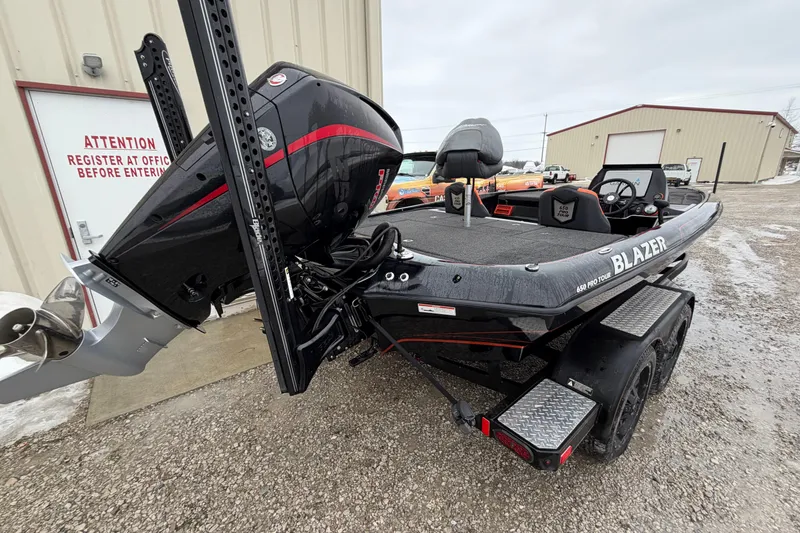 Slide: The Image of 2023 Blazer 650 Pro Tour boat with powerful outboard motor, parked outside a building. - 4