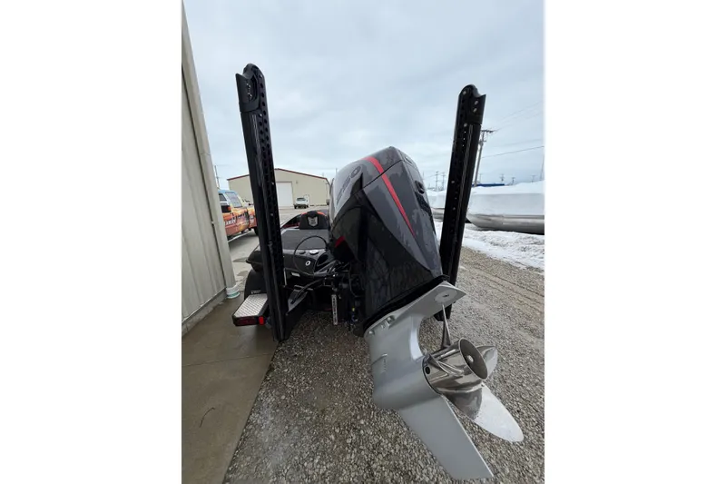 Slide: The Image of 2023 Blazer 650 Pro Tour boat with powerful outboard motor, parked outdoors. - 5