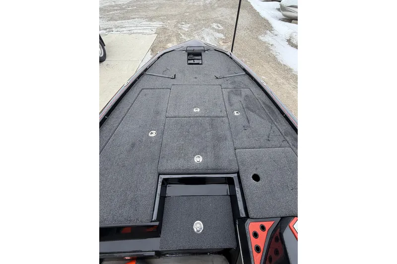 Slide: The Image of 2023 Blazer 650 Pro Tour boat deck with storage compartments, gray carpet, and sleek design. - 6