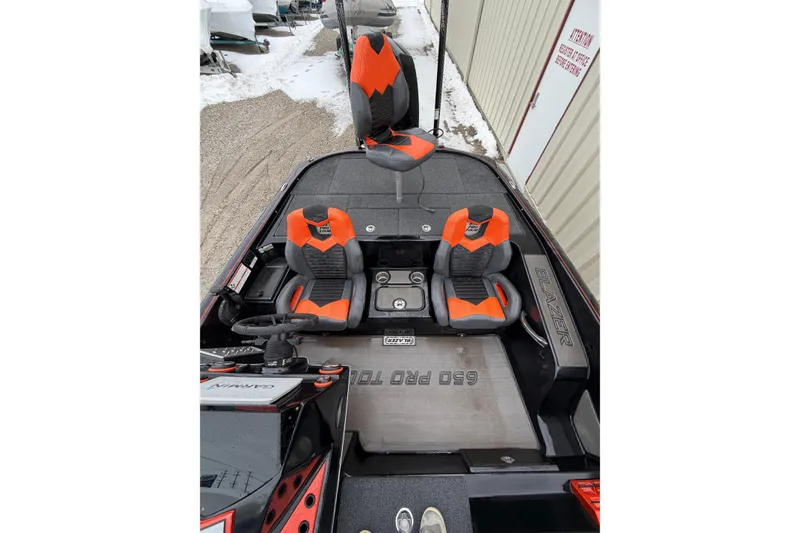 Slide: The Image of 2023 Blazer 650 Pro Tour boat interior with orange and gray seats, snowy background. - 7
