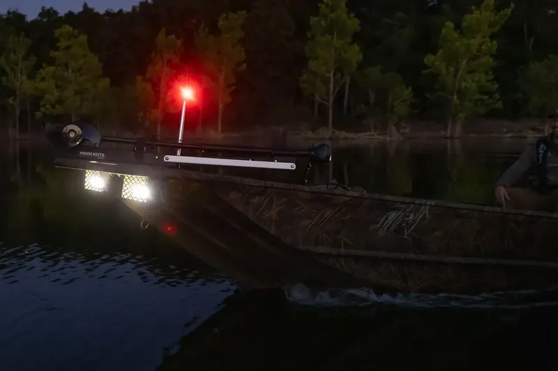 Slide: The Image of Manufacturer Provided Image: 2026 G3 Gator Tough 16 FL boat with lights on, navigating at dusk. - 2