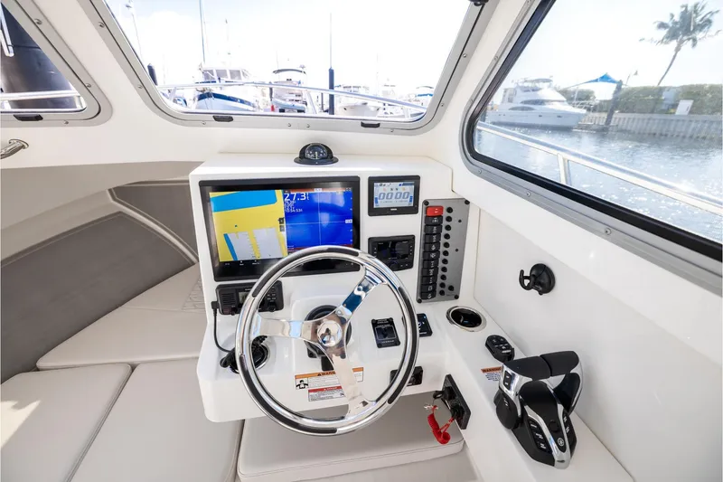 Slide: The Image of Interior helm of 2026 Parker 247 Explorer boat with modern navigation controls. - 6