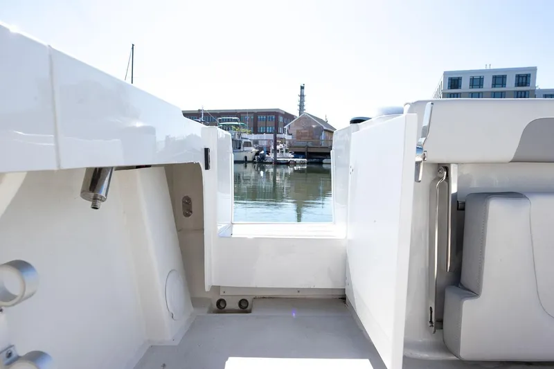Slide: The Image of Manufacturer Provided Image: 2026 Parker 257 Explorer boat interior with open door, dock view in background. - 8