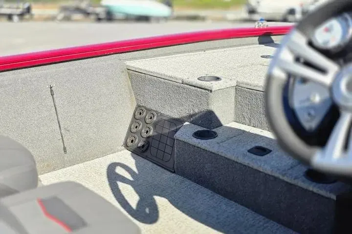Slide: The Image of 2021 Tracker Pro Team 195 TXW Tournament Edition boat interior with steering wheel and storage compartments. - 19