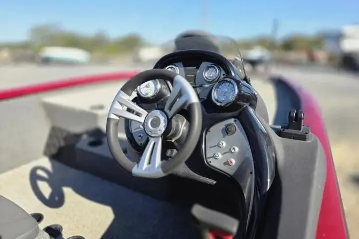 Slide: The Image of 2021 Tracker Pro Team 195 TXW Tournament Edition boat dashboard with steering wheel and gauges. - 20