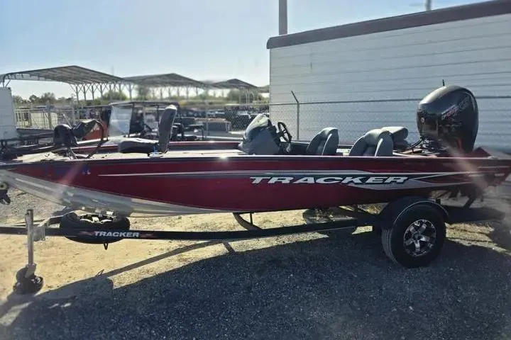 Slide: The Image of 2021 Tracker Pro Team 195 TXW Tournament Edition boat, red, parked on trailer. - 8