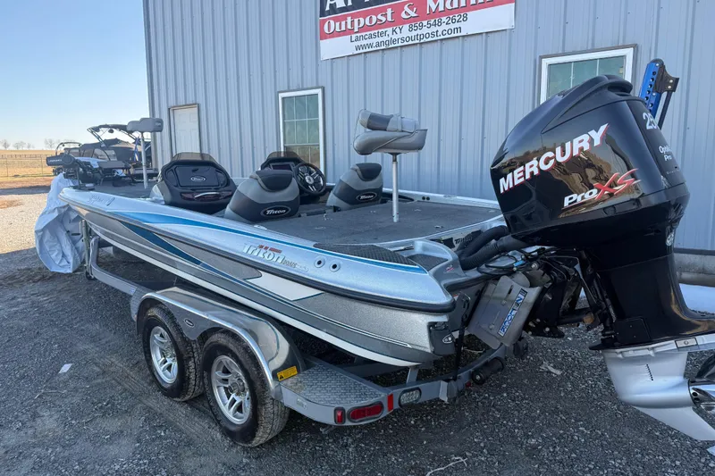 Slide: The Image of 2012 Triton 21HP boat with Mercury Pro XS engine parked outside a building. - 4