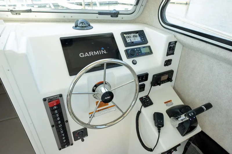 Slide: The Image of Manufacturer Provided Image: 2026 Parker 287 Explorer boat helm with Garmin navigation system and control panel. - 9