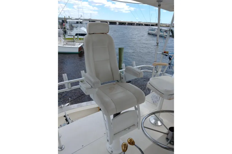 Slide: The Image of Captain's chair on 1999 Viking 45 Convertible yacht, overlooking marina. - 13