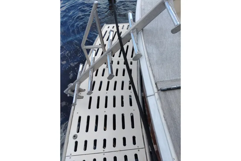 Slide: The Image of Boarding platform of a 1999 Viking 45 Convertible yacht with metal railings. - 16