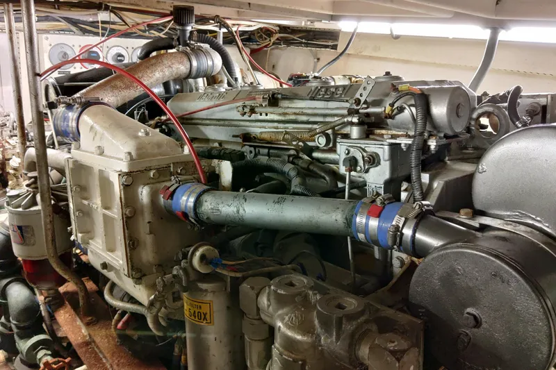 Slide: The Image of Engine room of a 1999 Viking 45 Convertible boat, showcasing detailed machinery components. - 19