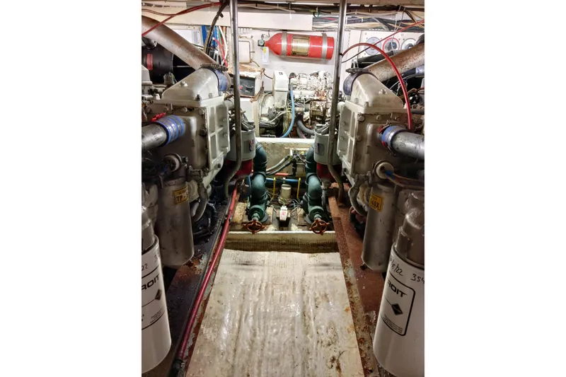 Slide: The Image of Engine room of 1999 Viking 45 Convertible yacht, showcasing dual engines and mechanical components. - 20