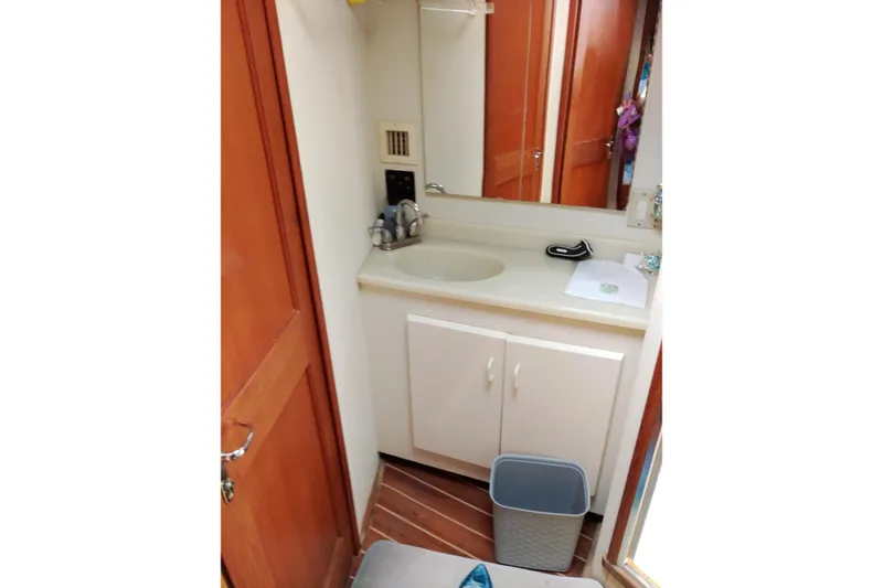 Slide: The Image of Bathroom interior of 1999 Viking 45 Convertible yacht with sink and mirror. - 29