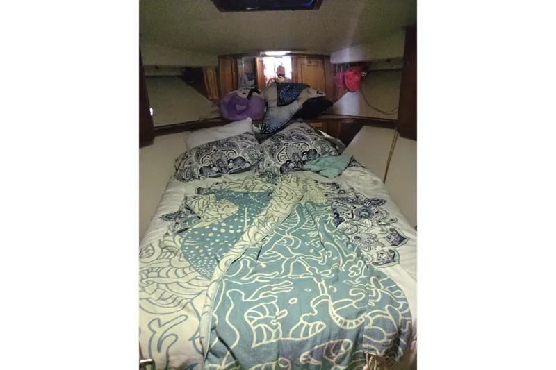 Slide: The Image of Cozy cabin bedroom in a 1999 Viking 45 Convertible boat with patterned bedding. - 30