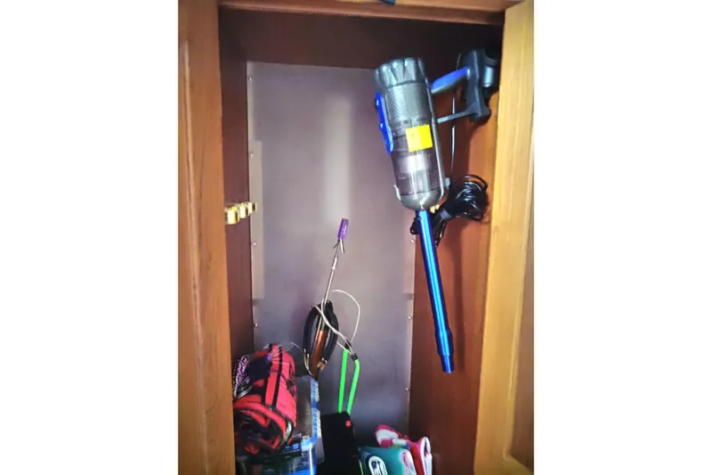 Slide: The Image of Storage closet on a 1999 Viking 45 Convertible yacht with vacuum and cleaning supplies. - 32