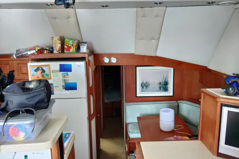 Slide: The Image of Interior of 1999 Viking 45 Convertible yacht with kitchen and seating area. - 48