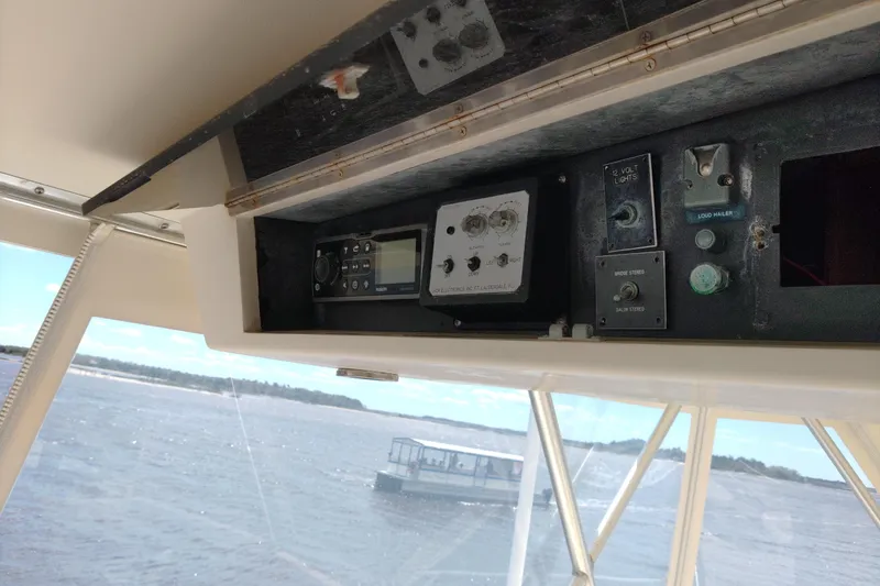 Slide: The Image of Control panel inside a 1999 Viking 45 Convertible boat with water view. - 8