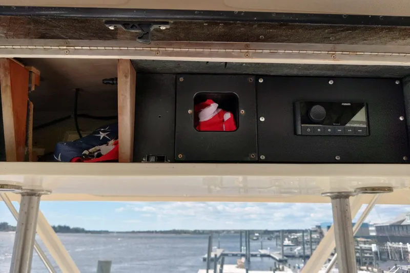 Slide: The Image of 1999 Viking 45 Convertible boat interior with storage compartment and control panel. - 9