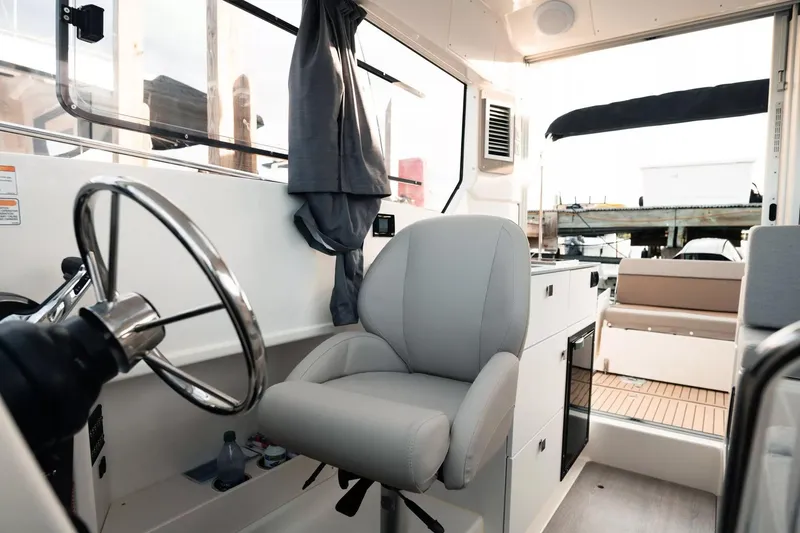 Slide: The Image of Interior of 2026 Trophy T25EX EXPLORER OB boat with steering wheel and seating. - 13