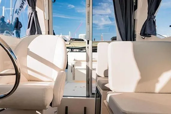 Slide: The Image of Interior view of 2026 Trophy T25EX EXPLORER OB boat with plush seating and modern design. - 14