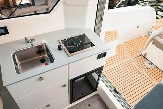 Slide: The Image of 2026 Trophy T25EX EXPLORER OB boat interior with kitchenette and teak flooring. - 16