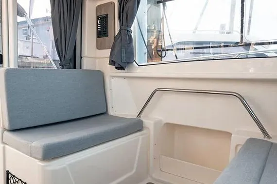 Slide: The Image of Interior of 2026 Trophy T25EX EXPLORER OB boat with cushioned seating and windows. - 17