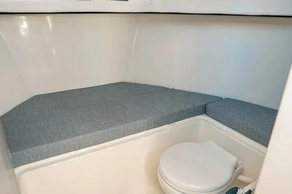 Slide: The Image of 2026 Trophy T25EX EXPLORER OB cabin interior with bed and toilet. - 19