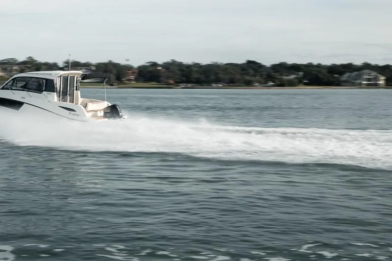 Slide: The Image of 2026 Trophy T25EX EXPLORER OB boat cruising on a serene lake. - 7